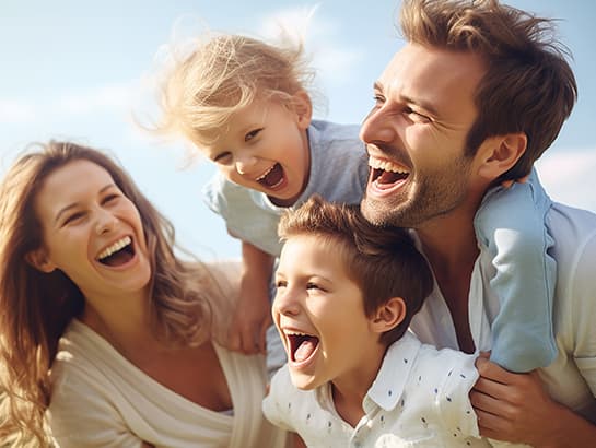 A happy family, the kind of full-family care Sauga Smiles Dental provides