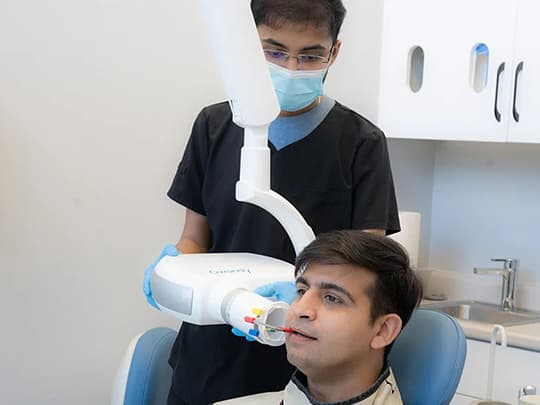 A member of the Sauga Smiles Dental team preparing a patient for treatment