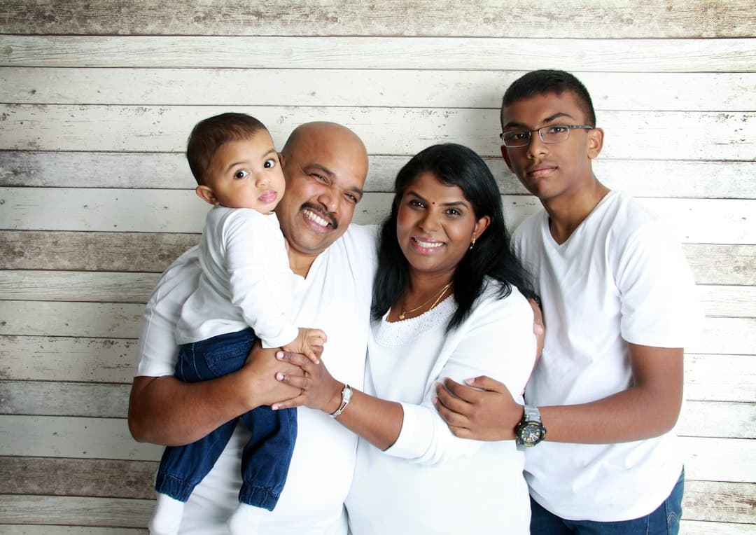 Family with children smiling outside Sauga Smiles Dental clinic in Mississauga